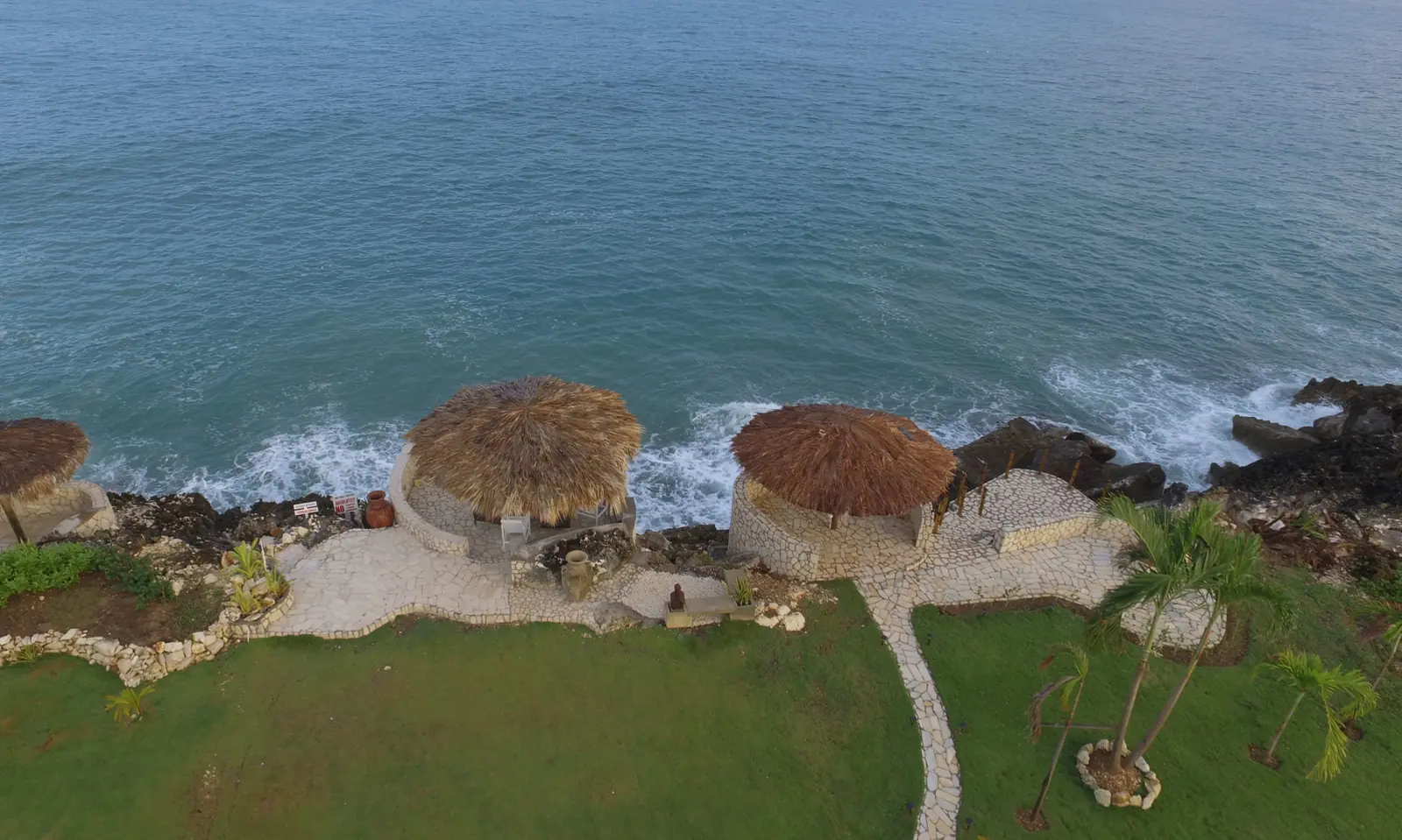 Gazebos above the rocky Caribbean coastline