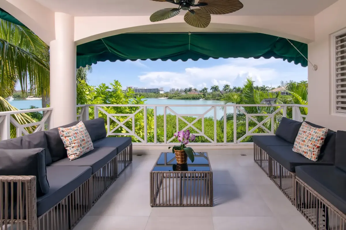 Grace’s covered balcony with seating overlooking the lagoon